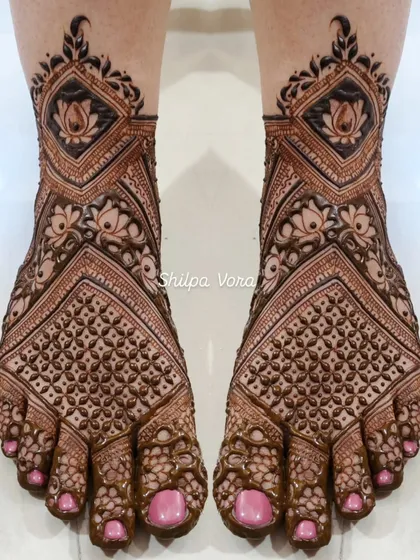 A full coverage bridal foot design with lotus flowers and dense geometric patterns, matching a full bridal hand design.