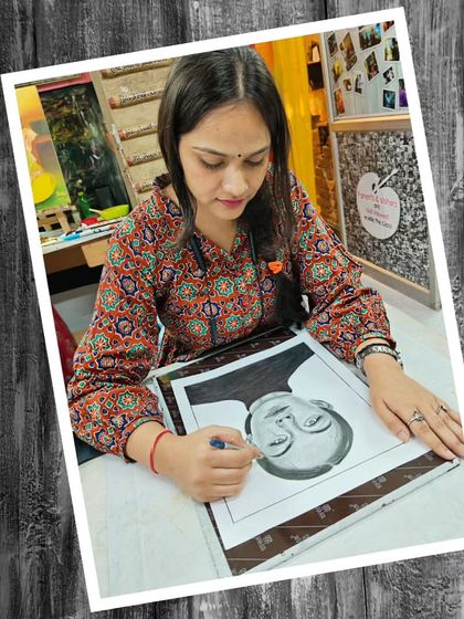 A student concentrating on her pencil portrait in the studio. We provide a focused environment for artists to hone their skills.