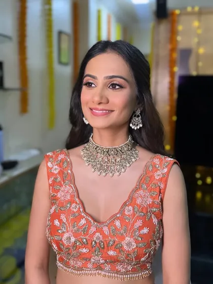 The client looking gorgeous for her Sangeet. The half-up style keeps the hair off her face, showing off her beautiful makeup and jewelry.