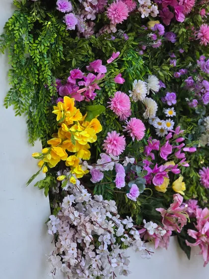 A close-up of the vibrant and textured 3D floral canvas, showcasing the variety of flowers and colors used to create this piece of art.