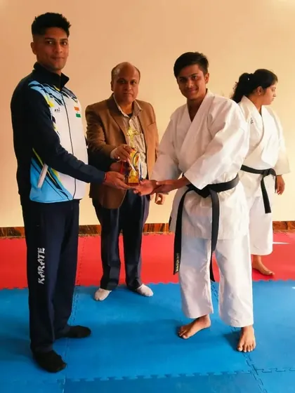 Another student being awarded his trophy after a successful black belt test. We celebrate every student's hard work.