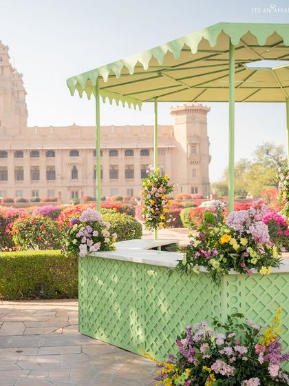 The elegant green bar stands in front of the palace's famous bougainvillea gardens, creating a picture-perfect scene.
