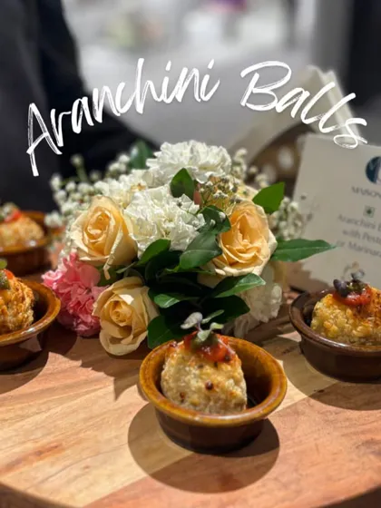 Golden-fried Arancini Balls filled with risotto and served with a pesto and marinara dip. These savory bites were a popular choice at the Maison Sia luxury launch.