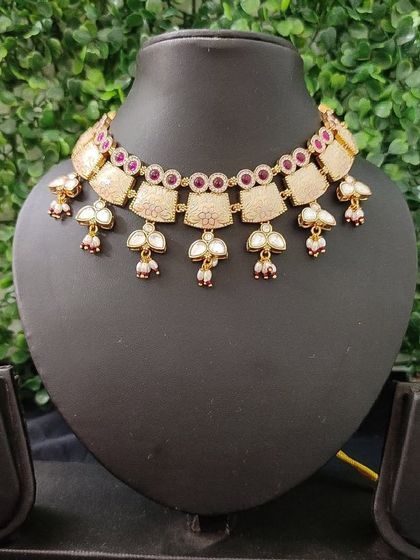 The full view of this charming pink enamel set, complete with necklace and matching earrings.