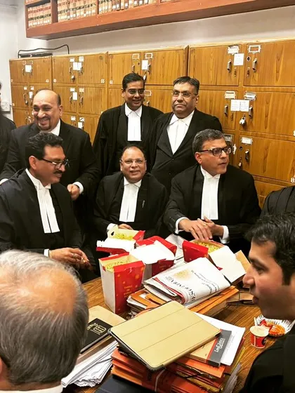 Sharing a moment with a wider group of colleagues in the bar room. A strong and connected legal fraternity is essential for a healthy justice system.