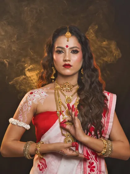 A graceful portrait of Maa Shailaputri, showcasing the traditional Bengali saree and makeup style.