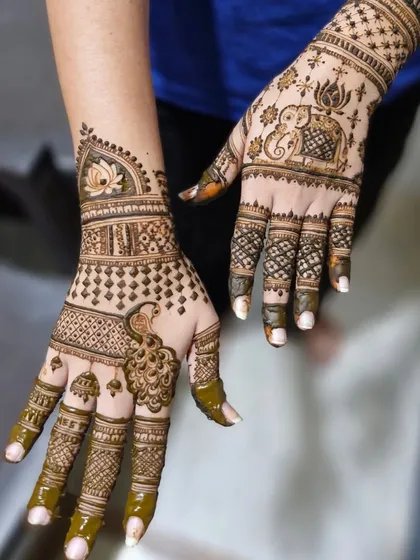 A lighter, more spaced-out traditional design, featuring a peacock, lotus, and elephant motifs. Perfect for pre-wedding functions.
