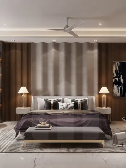 This expansive master bedroom features a dedicated reading corner with wingback chairs and a full-height bookshelf. The design uses a sophisticated palette of grays and rich woods to create a restful yet functional retreat.
