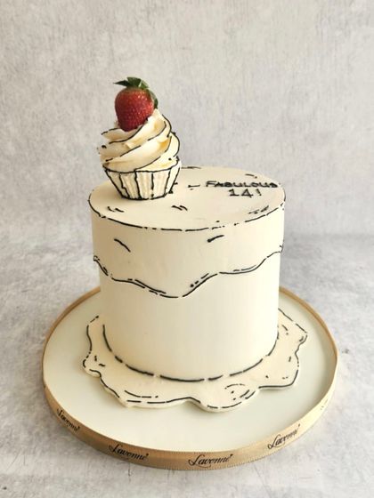 A fun comic-style cake. The black-and-white line work makes the cake look like a 2D drawing, with a single realistic strawberry on top for a pop of colour.