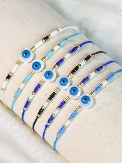 These minimal evil eye rakhis are perfect for a subtle touch of protection. The simple beaded design is both modern and timeless.