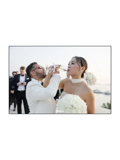 The couple shares a celebratory sip of champagne, a classic moment of joy and elegance following their ceremony.