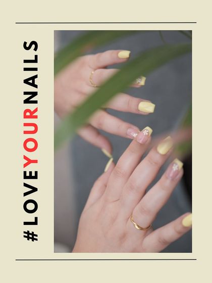 Another angle of the trendy butter yellow nails, showing how the combination of solid color and negative space art creates a balanced and stylish look.