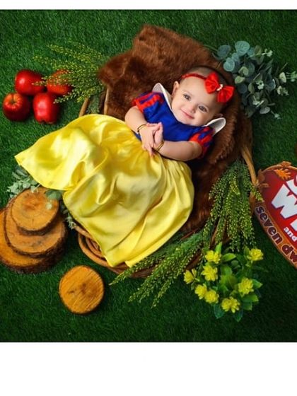 The fairest of them all. This adorable Snow White costume, with its signature blue bodice, yellow skirt, and red bow, was designed for a magical newborn photoshoot.