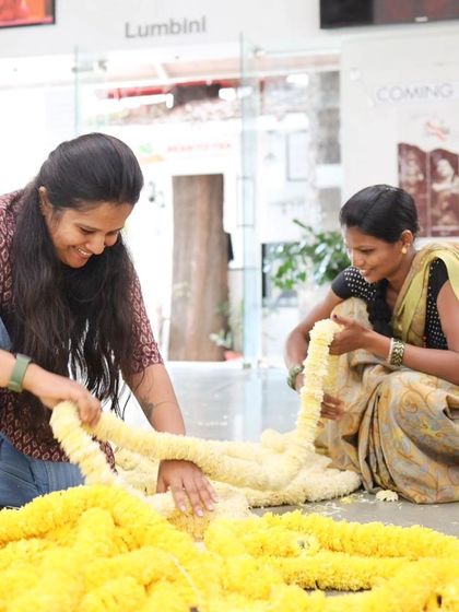 Our team members working together on the flower garlands.