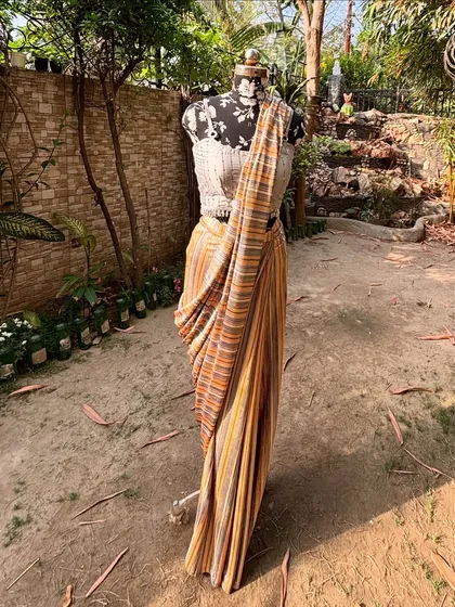 Another view of the striped saree, showing how beautifully it drapes. This is a perfect example of understated elegance.