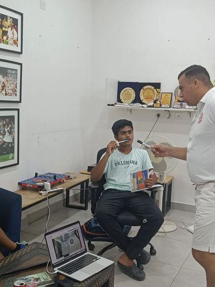 A coach interacts with a player during a mental training session, emphasizing the personalized approach we take to developing each athlete's mental fortitude.