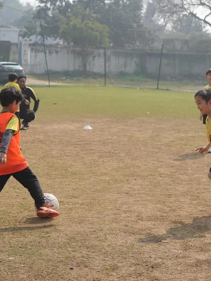 A young player practices ball control. We instill essential values from a tender age, and it all starts with focused, disciplined practice.