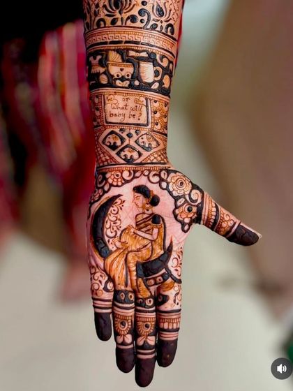 A creative baby shower mehandi showing a pregnant woman sitting on a crescent moon, with the question "Boy or Girl, what will baby be?" incorporated into the design.