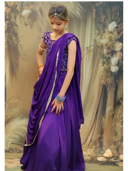 A full-length view of a young girl in a stunning purple lehenga for her Radha-themed photoshoot, showcasing the elegance of the outfit.