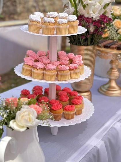 A tiered stand of delicious cupcakes, adding a pop of color and flavor to the Mehendi party.