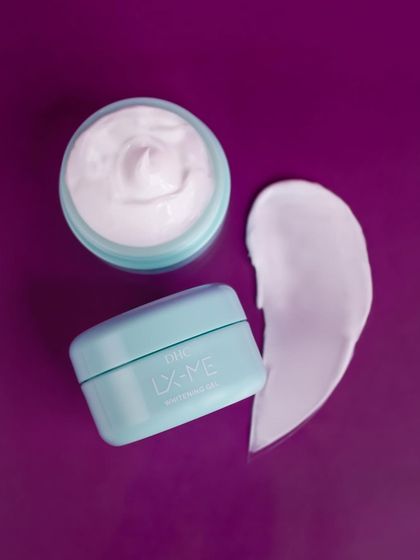 A texture shot for DHC Beauty, showing the rich, creamy swirl of the moisturizer next to the open jar. This type of shot is perfect for showcasing a product's luxurious feel.