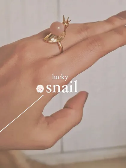 My lucky 'snáil' ring in peach moonstone, worn on the hand.