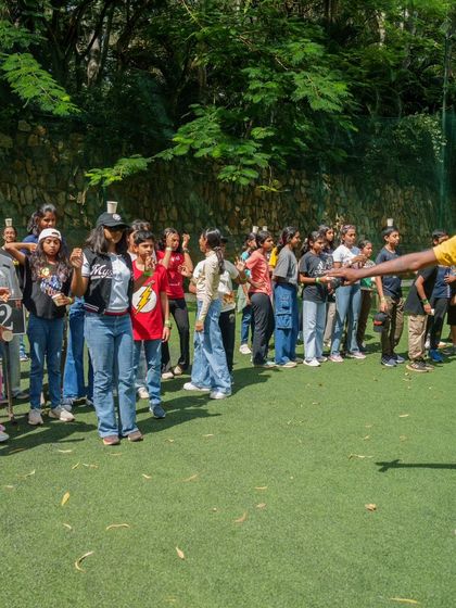 An instructor guides a group of students through a team building activity, making learning about teamwork fun and engaging.