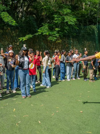 An instructor guides a group of students through a team building activity, making learning about teamwork fun and engaging.
