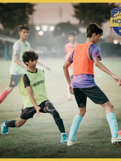 A training session still showing a player lunging to make a tackle. We teach our players to be committed and determined in every aspect of the game.