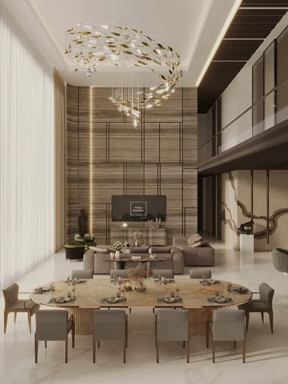 A glimpse into a double-height living and dining area we designed for a luxury penthouse in Mumbai. The space is defined by a dramatic sculptural chandelier, bespoke furnishings, and a mezzanine level, all curated to create an atmosphere of refined elegance.