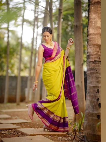 A playful pose in the classic lime green and purple pure Mysore crepe saree, showing its versatility and timeless style.