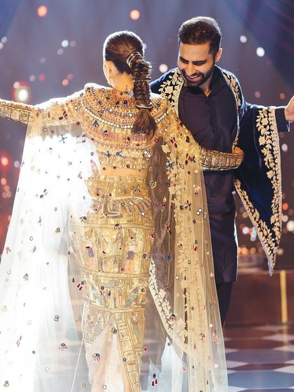 A beautiful moment from the couple's first dance, showcasing the intricate details of the bride's outfit and the pure happiness on their faces. We focus on creating choreography that allows for these picture perfect memories.