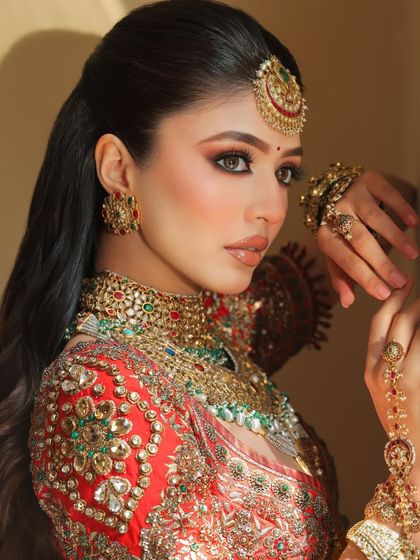 The perfect blend of tradition and artistry. This shot captures the intricate details of the eye makeup and how it pairs with the haath phool and other traditional jewelry.