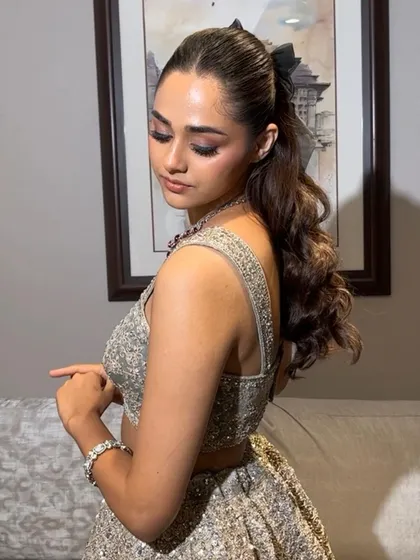 Another angle of this adorable bow ponytail. It's a simple accessory that can completely change the vibe of your hairstyle, making it perfect for a party.