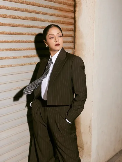 The movement of the tie in this shot adds a dynamic element to the otherwise structured and powerful suit.