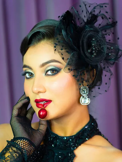 A playful and creative shot with a cherry. This shows how makeup can be part of a larger artistic concept, a skill useful for campaign shoots.