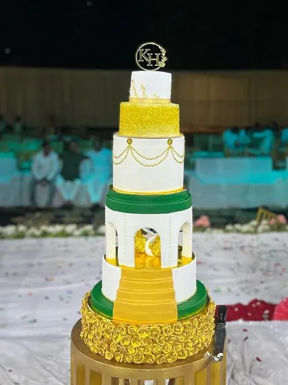 Our grand five-tier engagement cake set up at the venue, showcasing its impressive height and detailed craftsmanship.