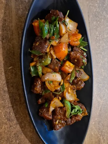 For those who love bold flavours, this is our Pork Dry Fry with Axone. The pork is stir-fried with onions, chillies, and the unique, pungent flavour of axone (fermented soybeans), a Naga delicacy.