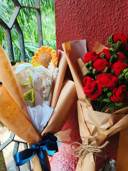 Two of my favorite bouquets together. It shows the versatility of crochet flowers, from a rustic red rose bouquet to a more delicate sunflower and lily arrangement.