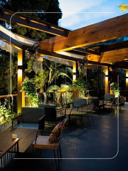 The outdoor seating area at Botanica provides a chic and comfortable space for an evening dinner or drinks, with warm lighting and a view of the gardens.