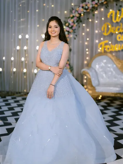 A full view of the magnificent blue gown. The simple, elegant makeup and hair allow the grandeur of the dress to take center stage.