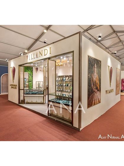 A three-quarter view of the Villandi '23 exhibition stall, showing the clean exterior walls used for branding and campaign imagery. The design presents a polished and complete architectural presence from all angles.