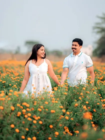 Walking hand-in-hand through a field of marigolds. For this nature-filled pre-wedding shoot, the goal was to create a feeling of pure, simple joy. The warm colors and the couple's easy smiles make this a perfect example of a romantic outdoor session.