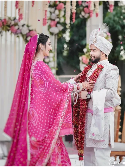 The beginning of the Varmala ceremony, a significant ritual signifying acceptance and the start of their life together.