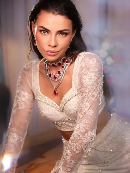 The spark of a white ensemble. This close-up highlights the intricate pearl work on the blouse and the stunning ruby and diamond necklace I selected.