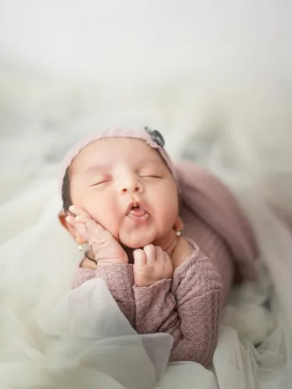 A tiny tongue-poking expression that is just too cute. I love catching these fleeting, funny faces that show off your baby's budding personality, even while they are dreaming.