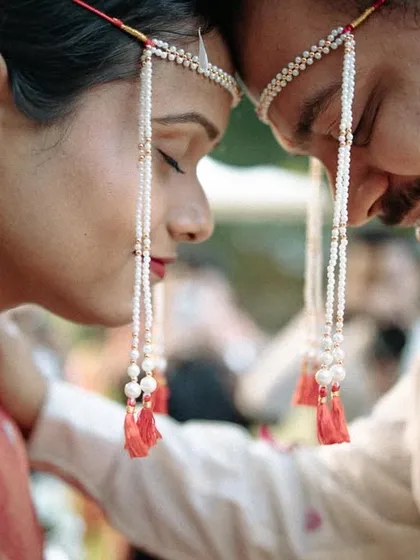 The moment just before the Antarpat is lowered, filled with anticipation and emotion. We focus on the couple's expressions, capturing the traditional Maharashtrian ceremony in a close, personal way.