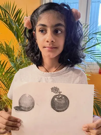 This artist displays her progress, showing both a sphere and a fully rendered apple, demonstrating her growing skill in 3D form and shading.