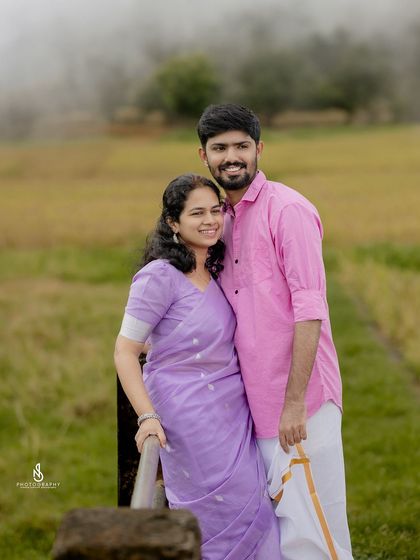 A sweet portrait on a small bridge in a misty, golden field. The complementary colors of their outfits look beautiful against the rustic backdrop.