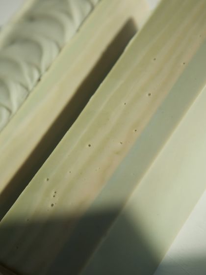 The smooth bottom of the 'Minty Breeze' loaf, showing the subtle swirls of natural colorants.